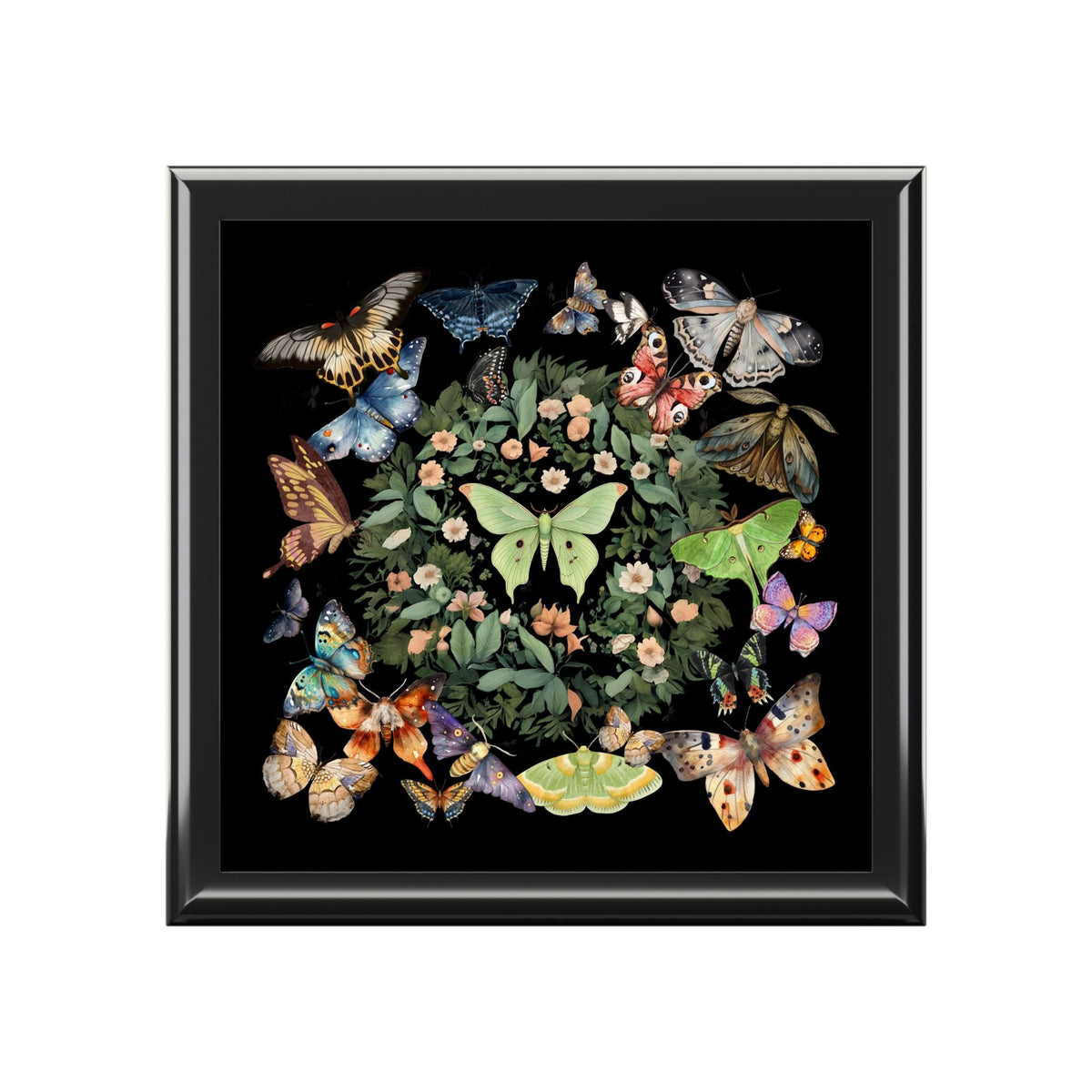 Top view of a black jewelry box lid with a green luna moth surrounded by butterflies and a floral wreath.