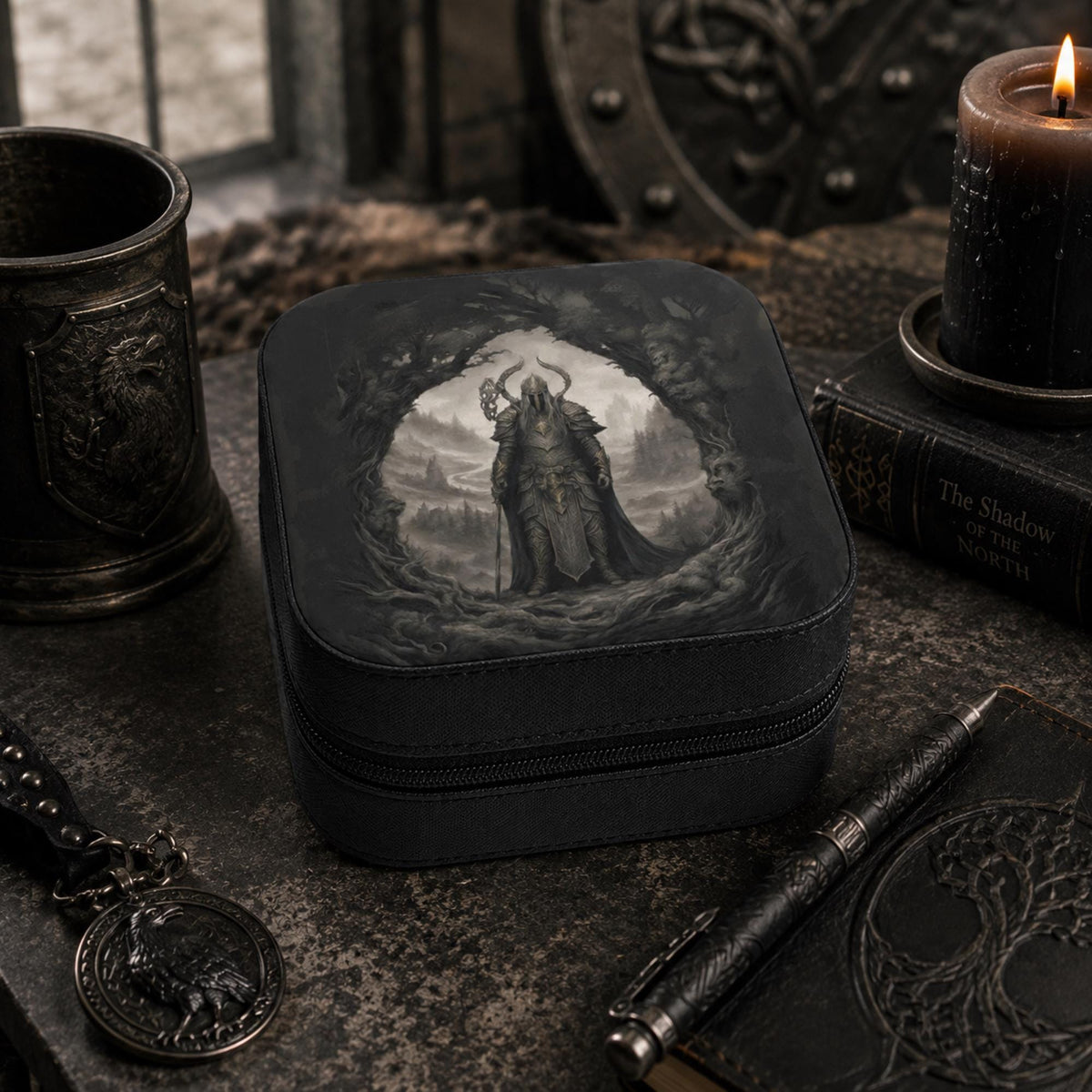 Angled view of a closed black warrior-print jewelry box beside a dark candle and goblet.
