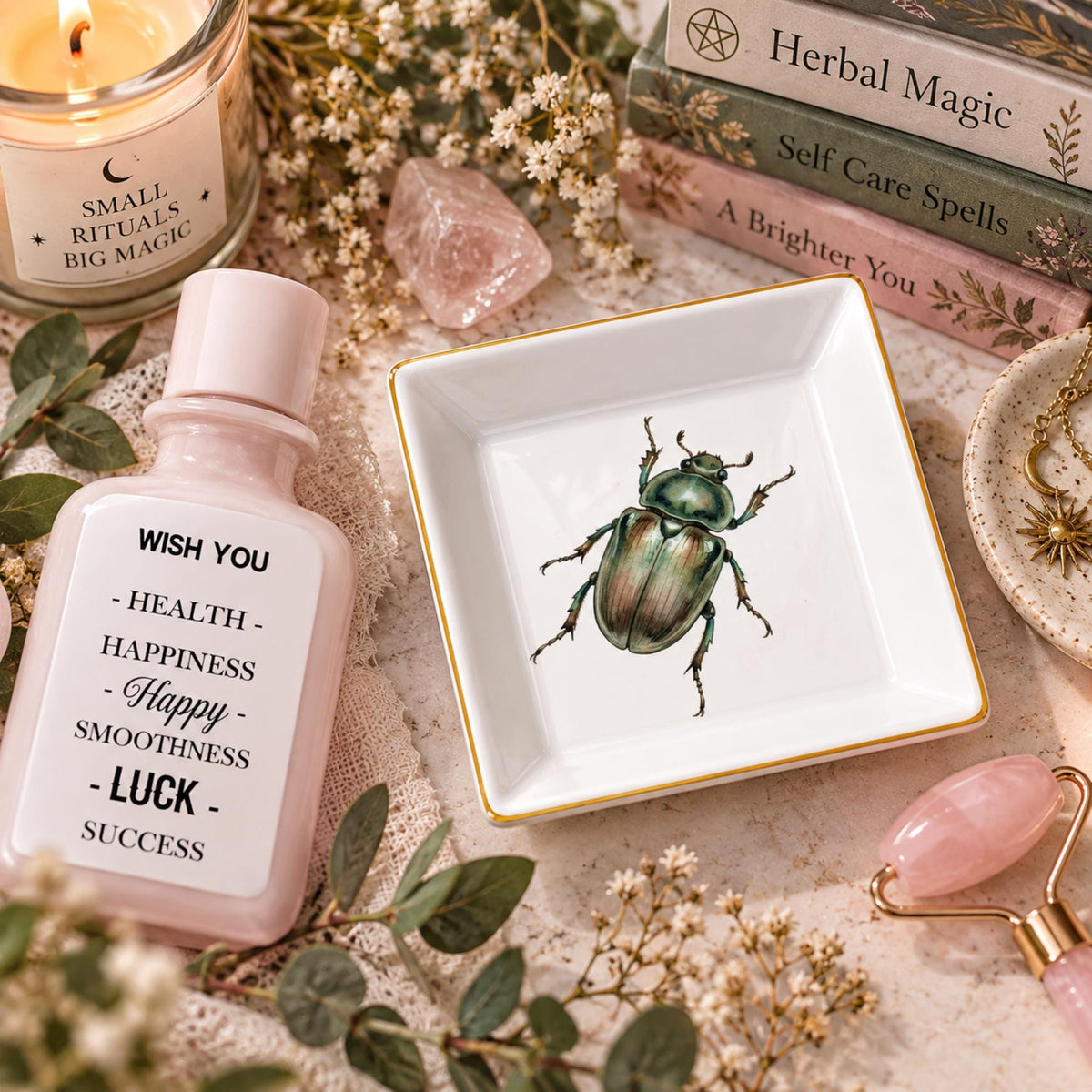 Empty white square beetle jewelry dish beside a pink lotion bottle and facial roller on a floral vanity.